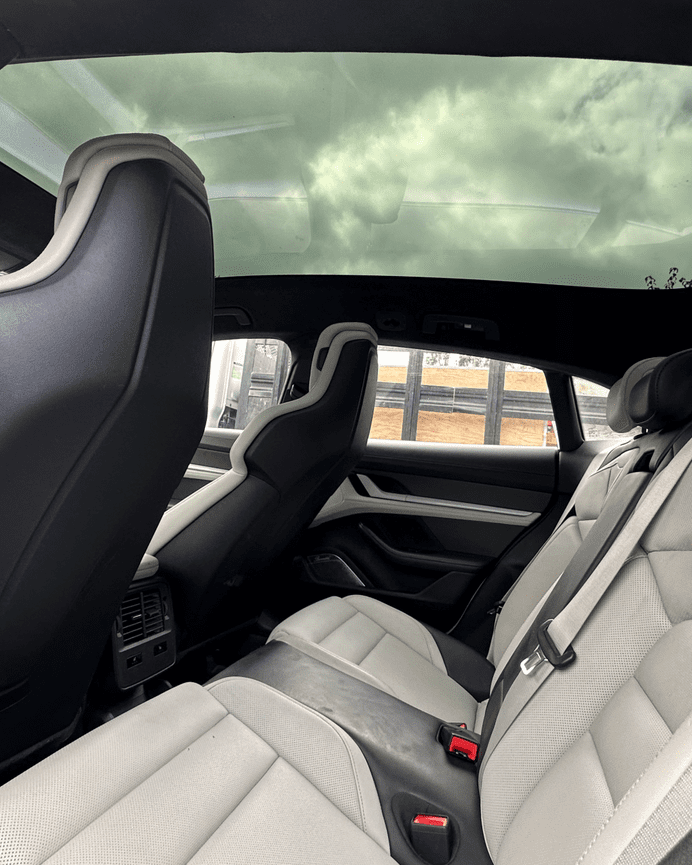 Interior view of Porsche Taycan panoramic glass roof from rear seats after replacement